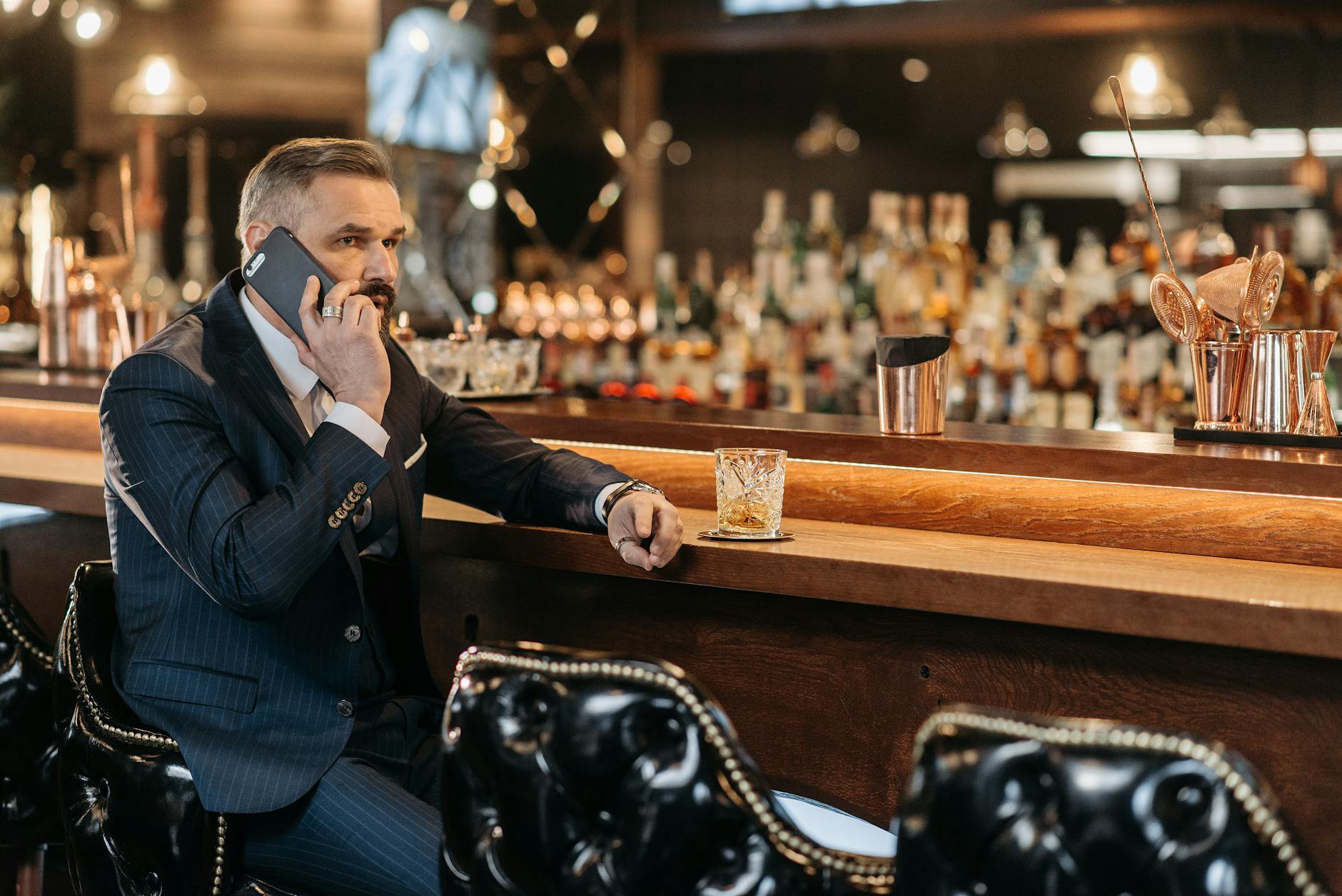 businessman talking on phone in bar