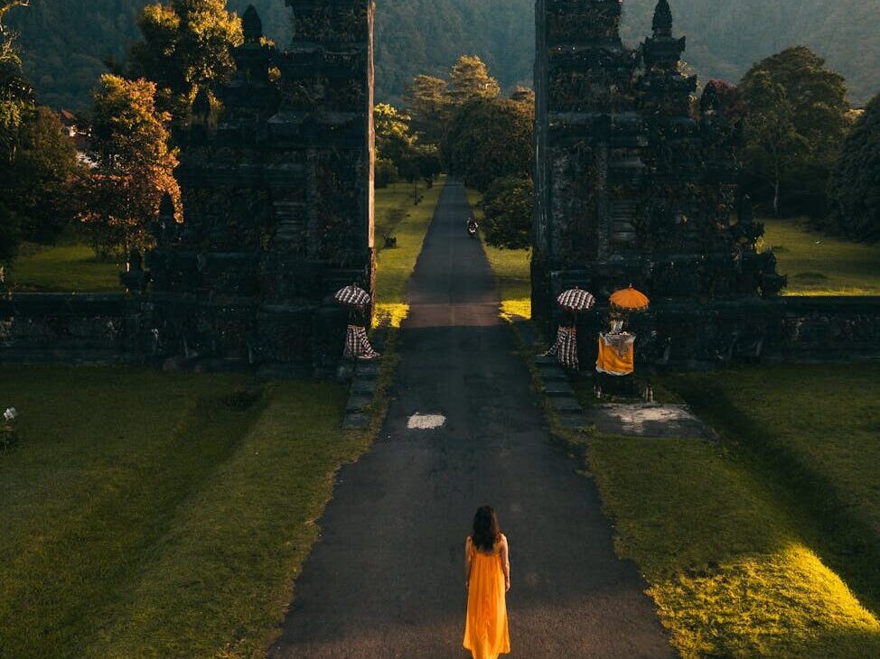 back view of a woman walking towards the famous bali handara gate