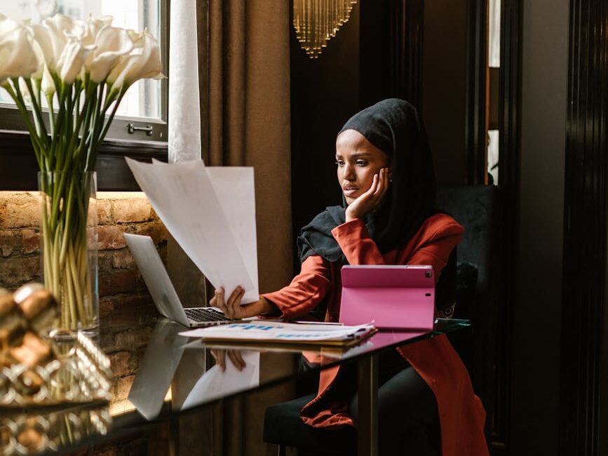 business tips for new entrepreneurs woman wearing black hijab looking at the papers