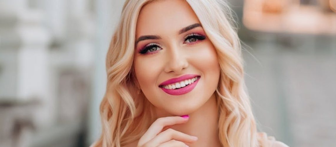 a beautiful blonde woman in a pink dress